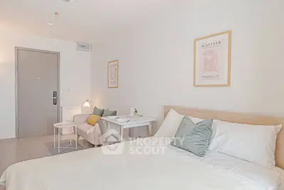 Cozy modern bedroom with stylish decor and natural light, perfect for relaxation and comfort.