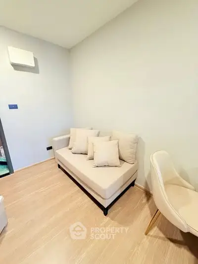 Cozy minimalist living room with beige sofa and wooden flooring