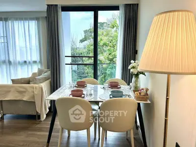 Chic dining area with elegant table setting and lush garden view, perfect for cozy gatherings.