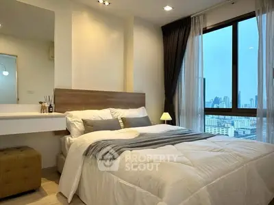 Modern bedroom with city view, cozy bedding, and stylish decor in a high-rise apartment.