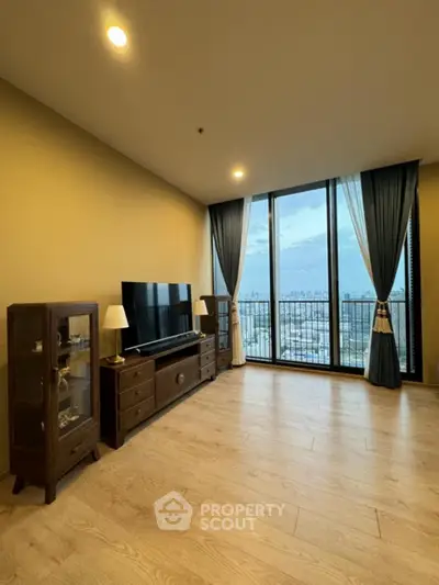 Spacious living room with large windows offering stunning city views