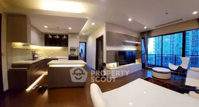 Modern open-plan living room and kitchen with city view and stylish decor.