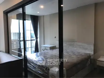 Modern bedroom with glass partition and balcony view in luxury apartment