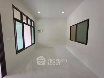 Spacious unfurnished room with large windows and modern tile flooring, perfect for customization.