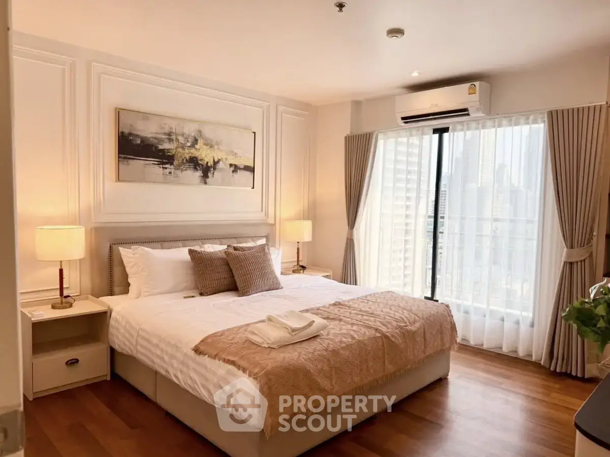Luxurious bedroom with elegant decor and city view, featuring a cozy bed and stylish lighting.