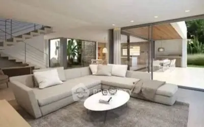 Spacious modern living room with large sectional sofa and glass doors opening to patio.
