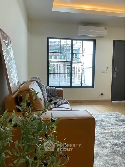 Modern living room with cozy sofa and large window view