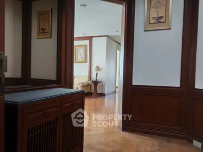 Elegant hallway with wooden accents leading to a cozy living area