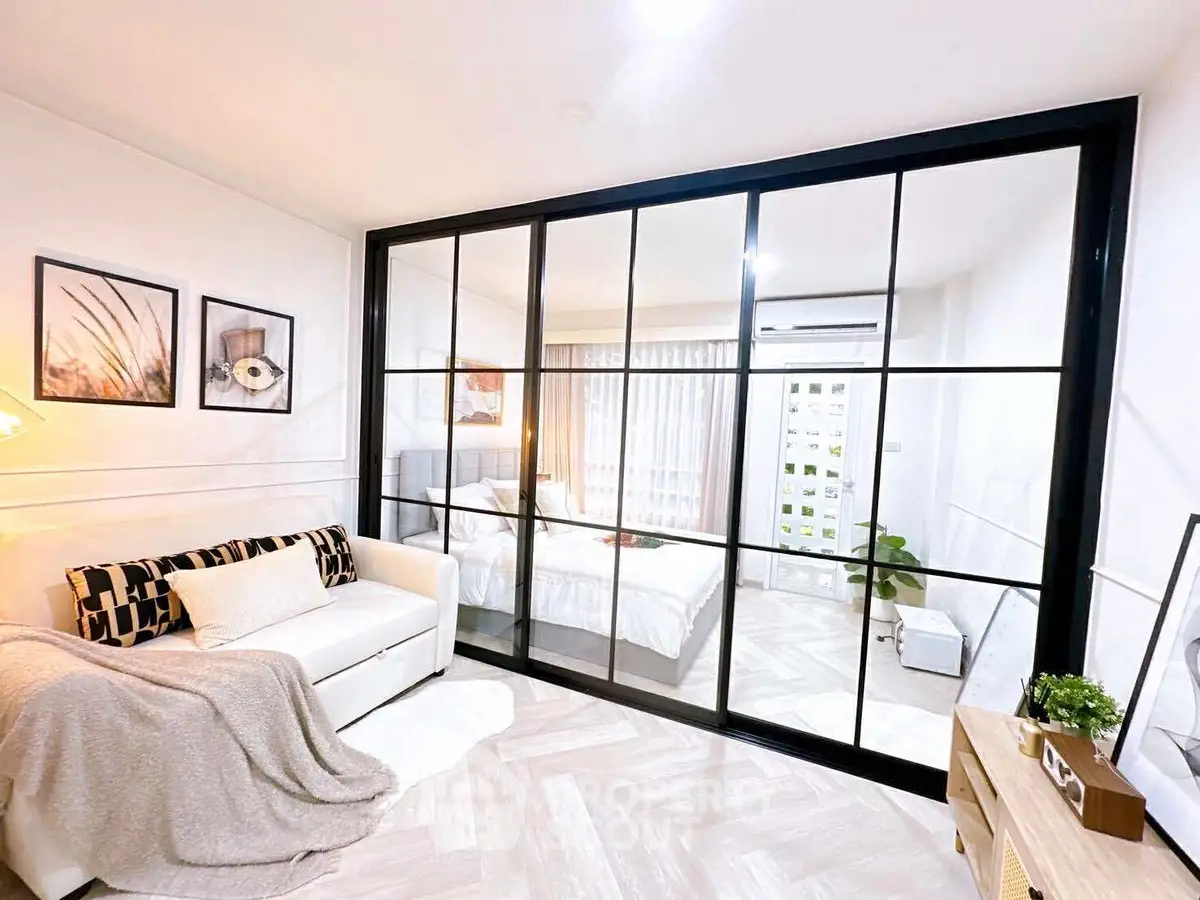 Modern living room with glass partition and cozy decor