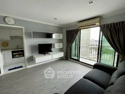 Modern living room with city view, featuring sleek furniture and large windows for natural light.