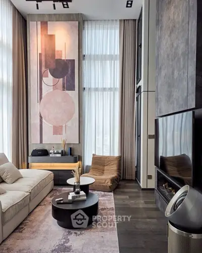 Modern living room with high ceilings, abstract art, and stylish furniture