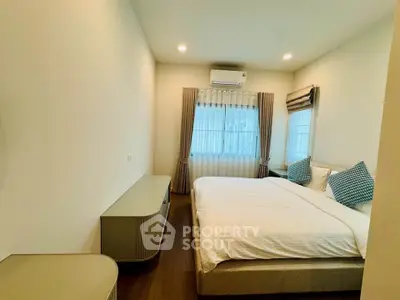 Cozy bedroom with modern furnishings and natural light