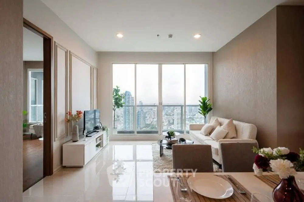 Modern living room with city view, elegant decor, and natural light.