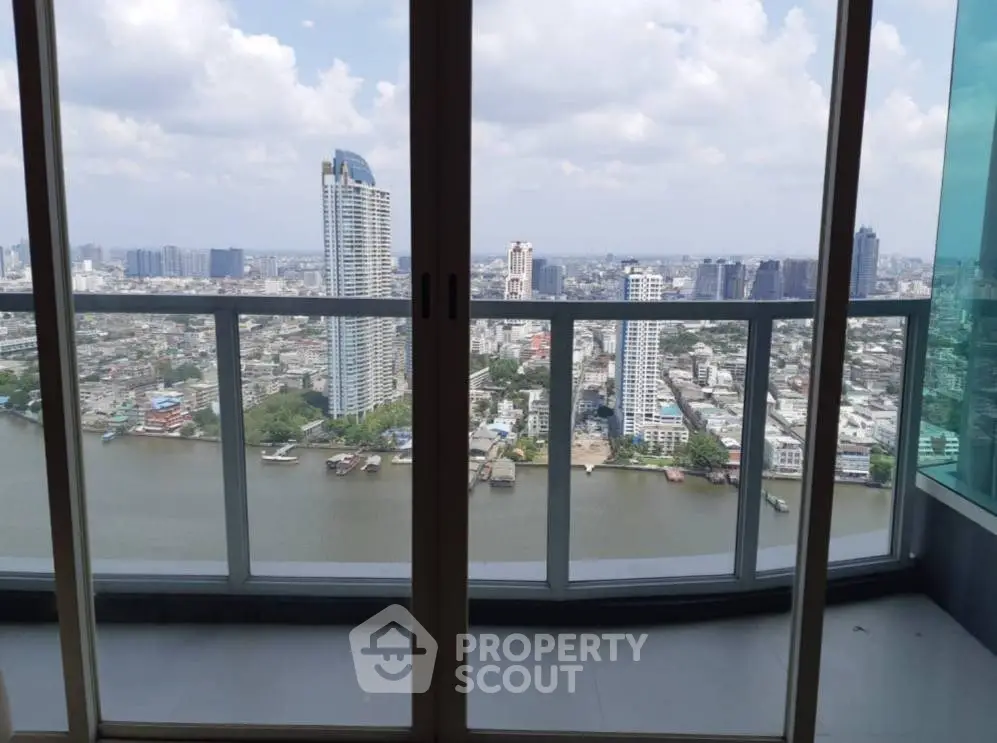 Stunning high-rise balcony view overlooking city skyline and river, perfect for urban living.