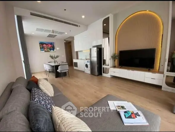 Modern open-plan living room with stylish kitchen and cozy seating area.
