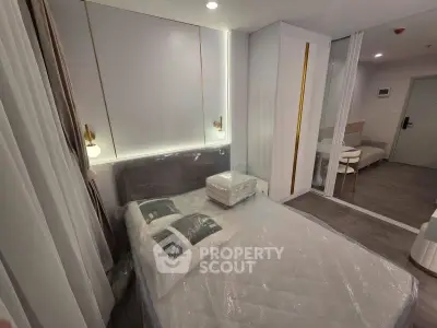Modern bedroom with sleek design and cozy ambiance, featuring stylish lighting and contemporary furnishings.