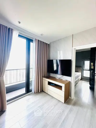 Modern living room with TV and balcony access in stylish apartment