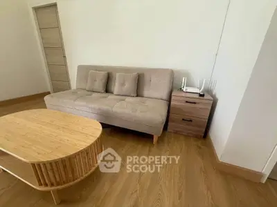 Cozy living room with modern sofa and wooden coffee table, perfect for relaxation.