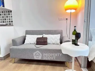 Modern living room with stylish gray sofa and elegant lighting