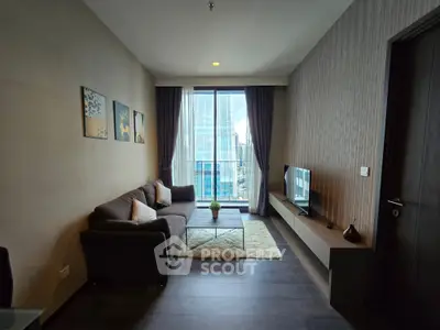 Modern living room with city view, stylish decor, and cozy seating area.