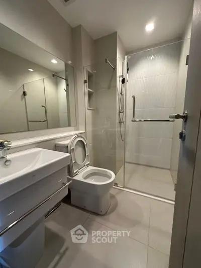 Modern bathroom with sleek fixtures and glass shower enclosure