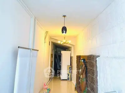 Bright hallway with modern lighting and decorative wall art in a stylish home.