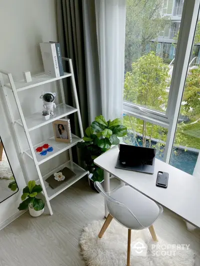 Bright study area with modern desk and large window view