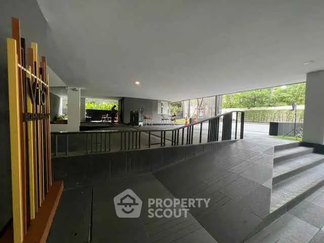 Modern building entrance with sleek design and accessible ramps