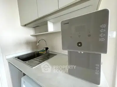 Modern kitchen with sleek water purifier and stainless steel sink