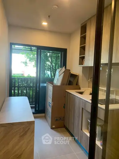 Modern kitchen with sleek cabinetry and large window overlooking greenery, perfect for culinary enthusiasts.