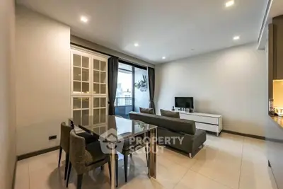 Modern living room with sleek furniture and city view balcony, perfect for urban living.