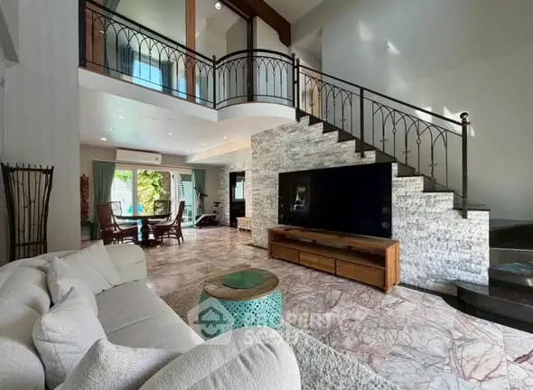 Spacious living room with modern design and elegant staircase in a luxurious home.