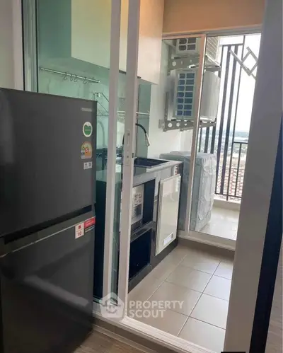 Modern kitchen with sleek appliances and balcony view, perfect for urban living.