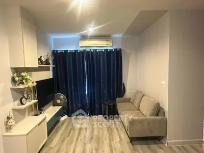 Modern living room with sleek furniture and stylish decor, featuring a cozy sofa and elegant shelving.