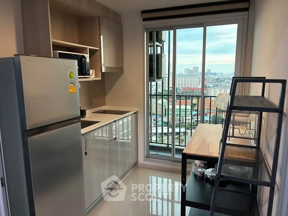 Modern kitchen with sleek appliances and city view from balcony