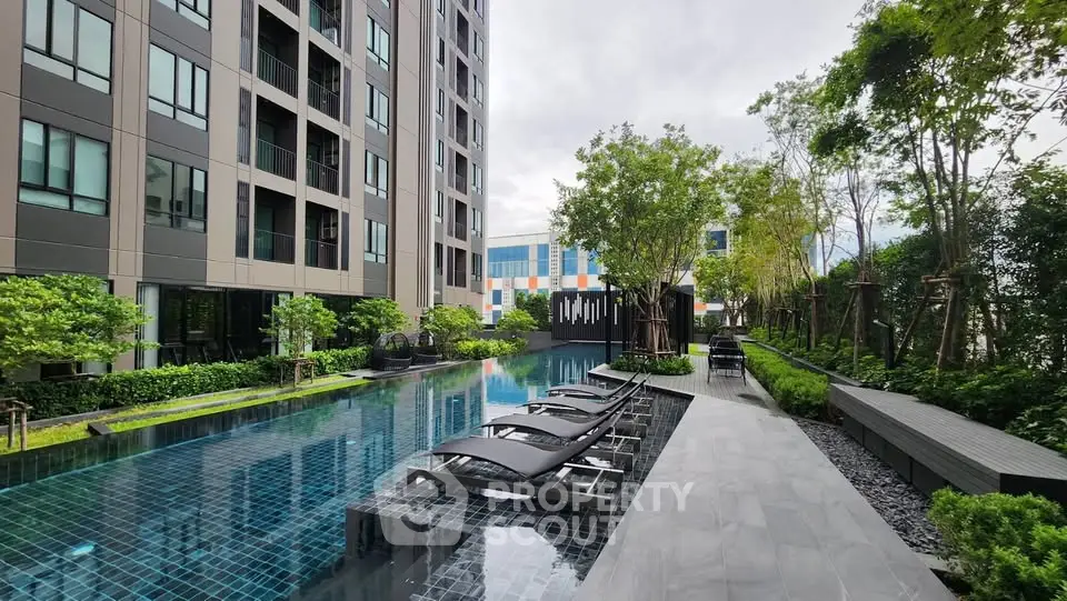 Luxurious condominium with modern pool and lush garden, perfect for relaxation and leisure.