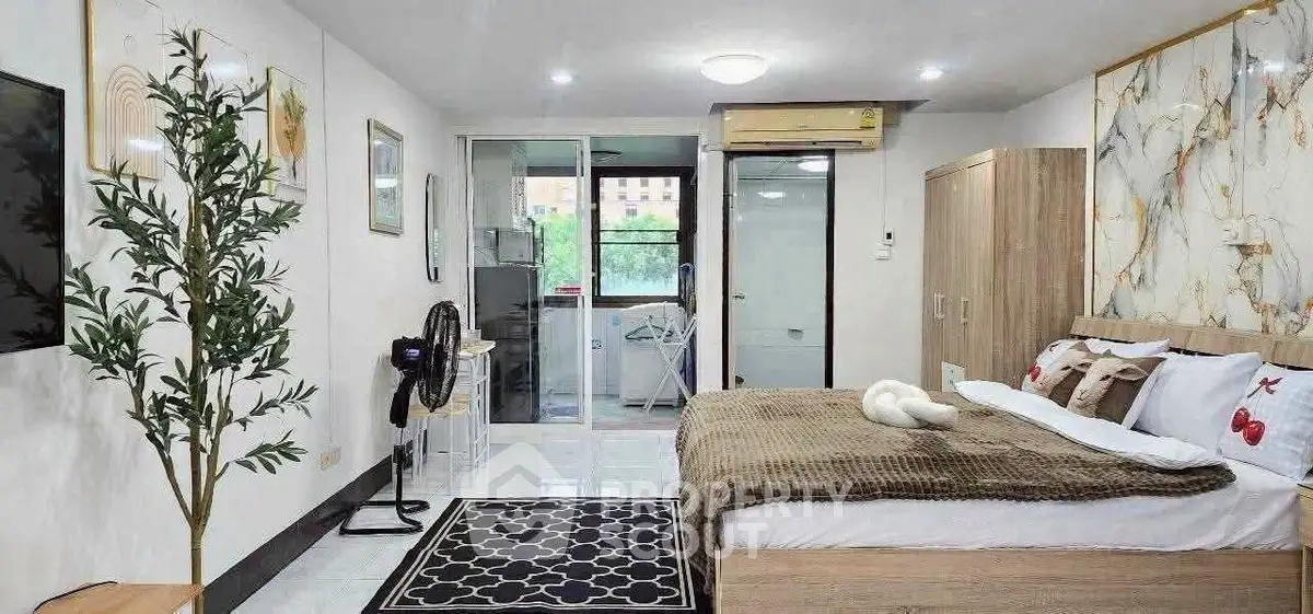 Spacious modern bedroom with stylish decor and large windows offering natural light.