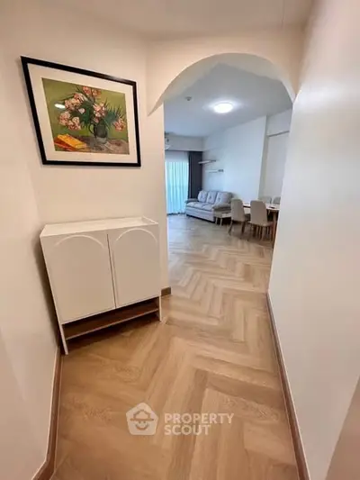 Spacious living room with elegant decor and wooden flooring, perfect for modern living.