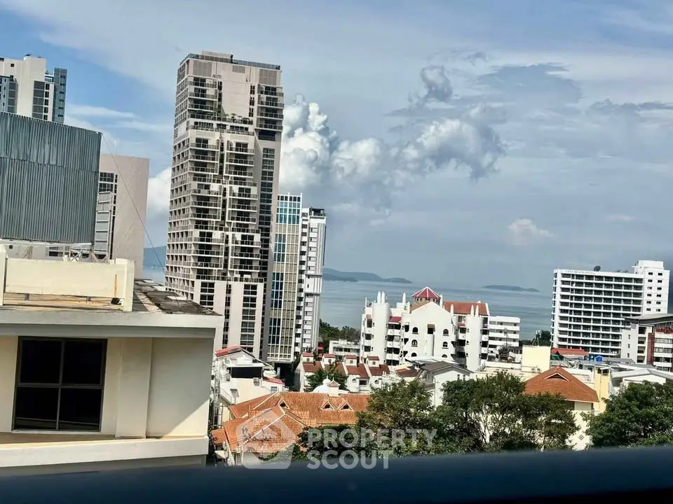 Stunning cityscape view with modern high-rise buildings and ocean backdrop, perfect for urban living enthusiasts.