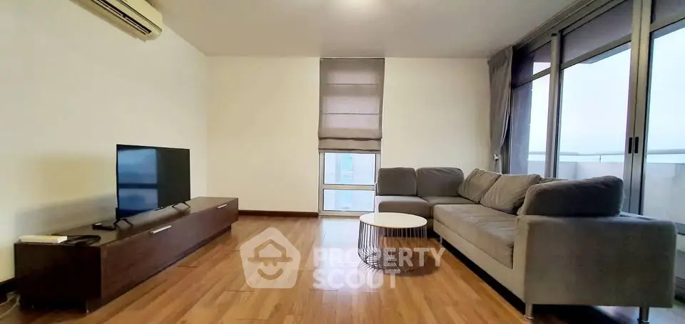 Spacious modern living room with large windows and stylish furniture