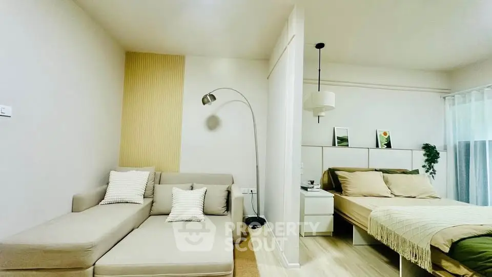 Modern studio apartment with cozy living area and stylish bedroom