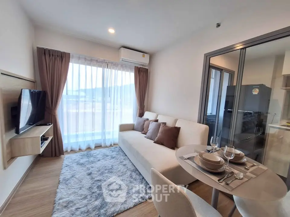 Modern living room with cozy sofa and dining area in a bright apartment.