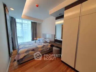 Modern bedroom with stylish decor and ample natural light