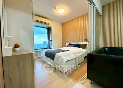Modern bedroom with city view, featuring sleek design and cozy ambiance.