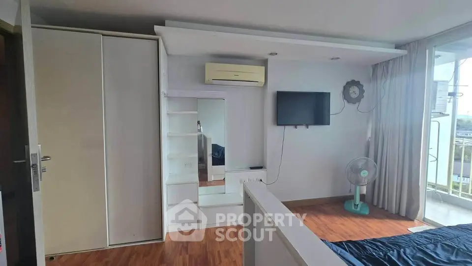 Modern bedroom with air conditioning and balcony view