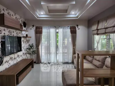 Spacious living room with modern decor and large windows for natural light.