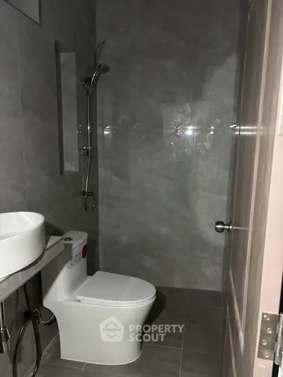 Modern bathroom with sleek fixtures and elegant gray tiles
