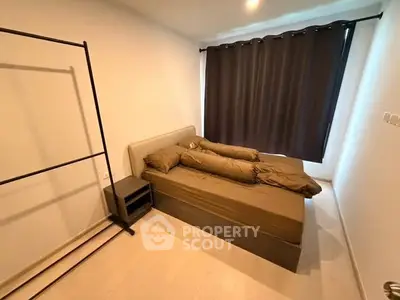 Cozy bedroom with minimalist design and dark curtains for privacy.