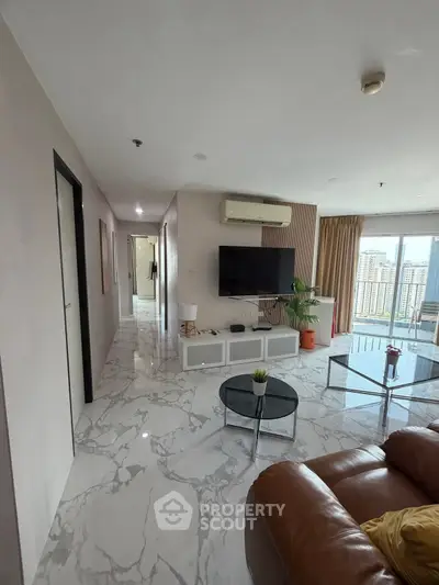 Spacious modern living room with marble flooring and city view balcony