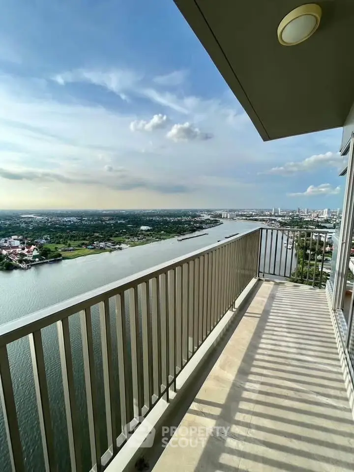 Stunning river view from a high-rise balcony with expansive cityscape.
